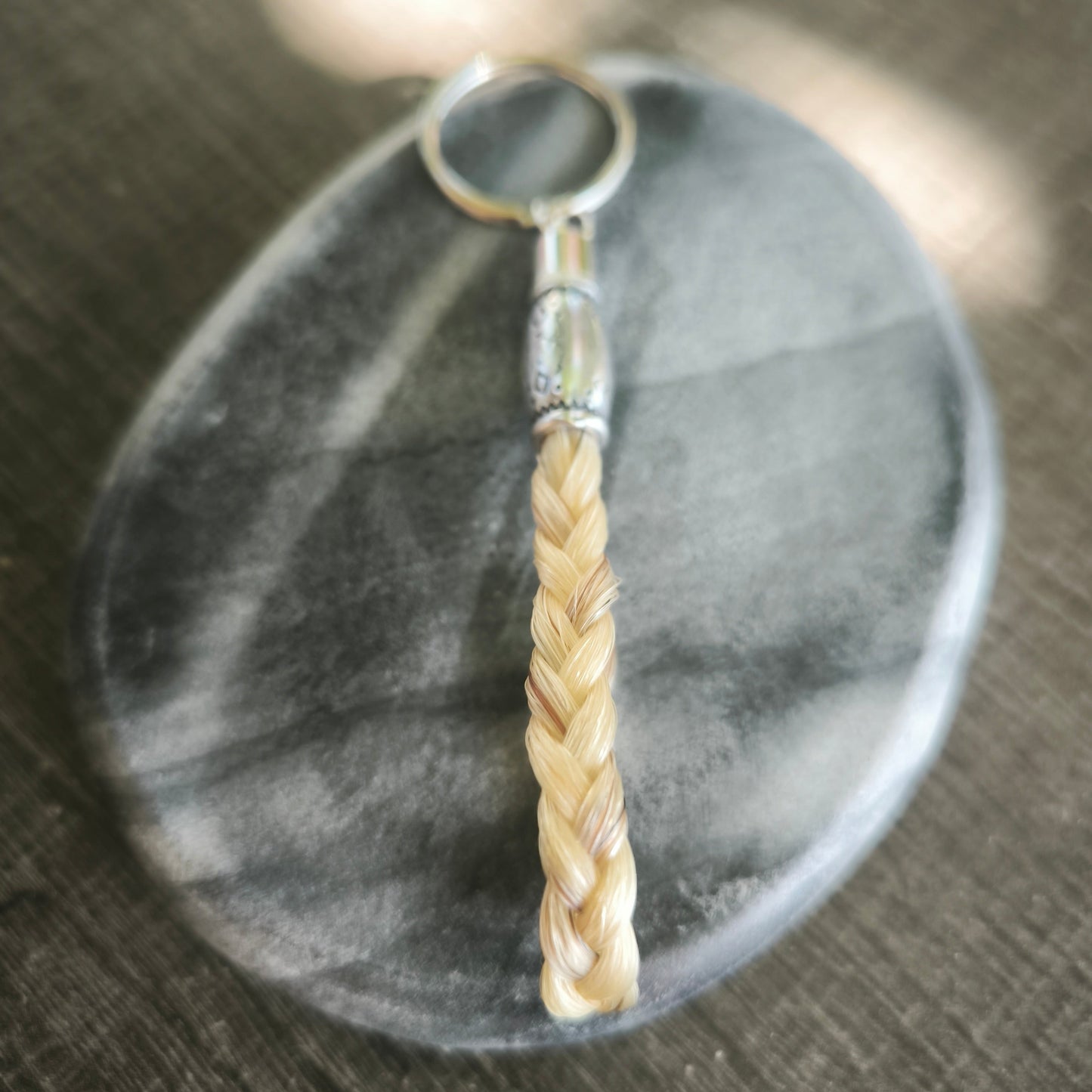 Le porte-clé Caelindra réalisé par Calesthiel, créatrice française, en crins naturels et acier inoxydable.